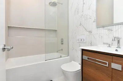 a bathroom with a shower and a toilet and a sink at Boho Rustic Escape with Masssive Terrace in Midtown in New York