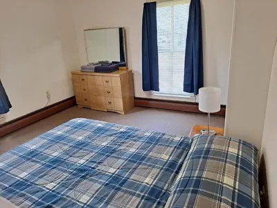 a bedroom with a bed and a dresser and a mirror at The Canton House