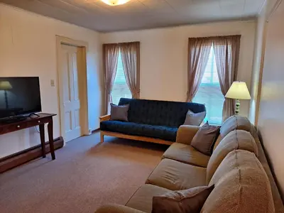 a living room with a couch and a tv at The Canton House
