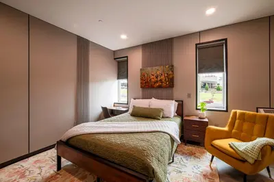 a bedroom with a bed and a yellow chair at 4505 Lofts in Vestal