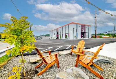 two wooden chairs sitting on the side of a street at 4505 Lofts in Vestal