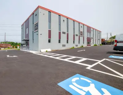 a parking lot with a building with a handicapped sign at 4505 Lofts in Vestal