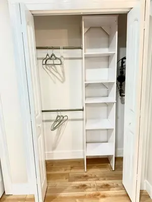 a walk in closet with white shelves at The Canopy 4BR Forest Escape Spa, Sip, and Unwind in Vernon Township