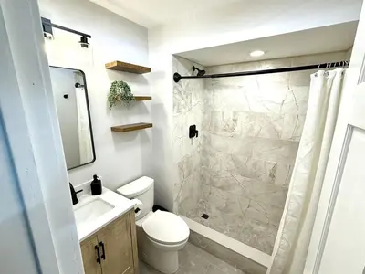 a bathroom with a shower and a toilet and a sink at The Canopy 4BR Forest Escape Spa, Sip, and Unwind in Vernon Township