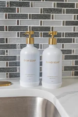 two bottles of hand soap sitting on a bathroom sink at Style & Comfort 3 Rooms -15 min from NYC in West New York