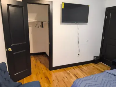 a room with a mirror and a tv on the wall at Log Comfort in Newark