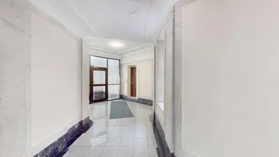 a hallway of a house with white walls and a window at Sunny 4BR/2BA Retreat in Morningside Heights, NYC in New York