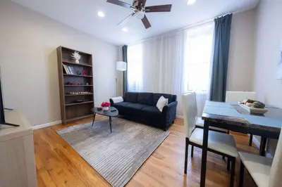 a living room with a couch and a table at Sunny 4BR/2BA Retreat in Morningside Heights, NYC in New York