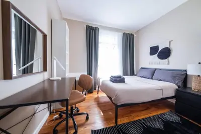 a bedroom with a bed and a desk in it at Sunny 4BR/2BA Retreat in Morningside Heights, NYC in New York
