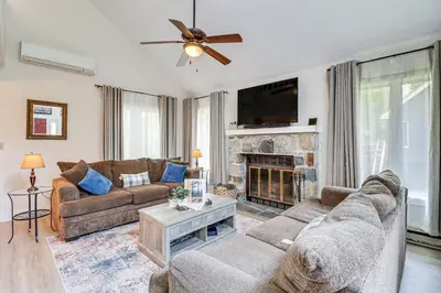 a living room with two couches and a fireplace at Steps to Jack Frost Ski Resort Townhome with Decks in Lake Harmony