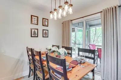a dining room with a wooden table and chairs at Steps to Jack Frost Ski Resort Townhome with Decks in Lake Harmony
