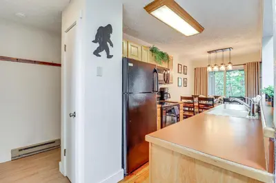 a kitchen with a refrigerator and a counter top at Steps to Jack Frost Ski Resort Townhome with Decks in Lake Harmony