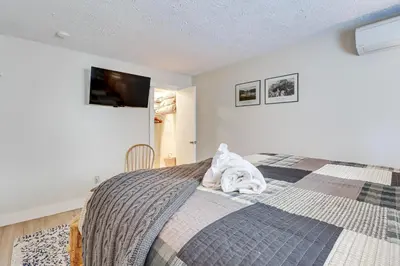 a bedroom with a bed with a towel on it at Steps to Jack Frost Ski Resort Townhome with Decks in Lake Harmony