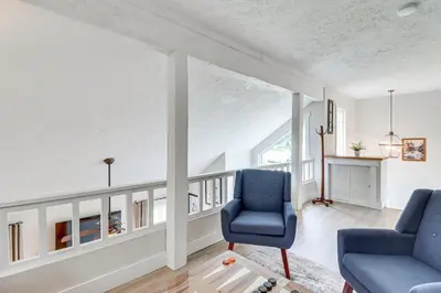 a living room with two chairs and a fireplace at Steps to Jack Frost Ski Resort Townhome with Decks in Lake Harmony