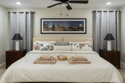 a bedroom with a large bed with two towels on it at Group-Friendly Luxury 3BR 2 Baths Sleeps 8 in Irvington