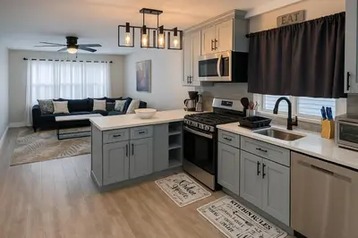 a kitchen and living room with a couch at Group-Friendly Luxury 3BR 2 Baths Sleeps 8 in Irvington