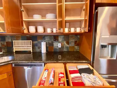a kitchen with a counter top with a wooden drawer at Easy PATH&Bus access- NYC designer home & Terrace in Jersey City