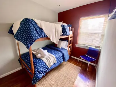 a bedroom with two bunk beds and a window at Comfortable home close to Manhattan,Wall St & more in Jersey City