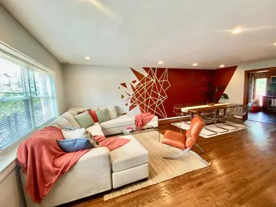 a living room with a couch and a table at Comfortable home close to Manhattan,Wall St & more in Jersey City