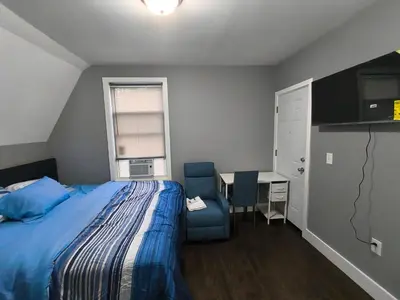a bedroom with a bed and a desk and a chair at Log Comfort 2 in Newark