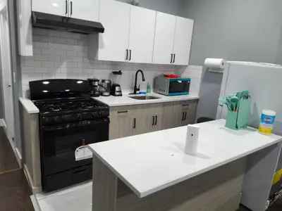 a small kitchen with a stove and a sink at Log Comfort 2 in Newark