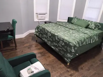 a bedroom with a bed and a couch and a desk at Log Comfort 2 in Newark
