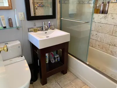a bathroom with a sink and a shower and a toilet at Airy brownstone penthouse duplex near Central Park in New York