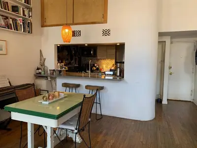 a kitchen and dining room with a table and chairs at Airy brownstone penthouse duplex near Central Park in New York
