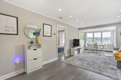 a living room with a couch and a mirror at Cozy Lakefront House with a private dock and lake in Hopatcong