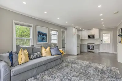 a living room with a couch and a kitchen at Cozy Lakefront House with a private dock and lake in Hopatcong