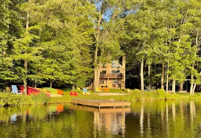 a view of a lake with a house in the background at Swept Away in Arrowhead Lake in Arrowhead Lake