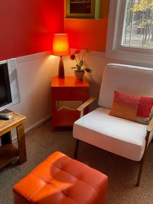 a room with a chair and a table with a lamp at Swept Away in Arrowhead Lake in Arrowhead Lake