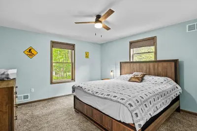 a bedroom with a bed and a ceiling fan at Hot Tub and Community Beach Albrightsville Home! in Albrightsville
