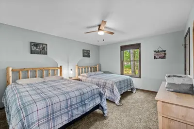 a bedroom with two beds and a ceiling fan at Hot Tub and Community Beach Albrightsville Home! in Albrightsville