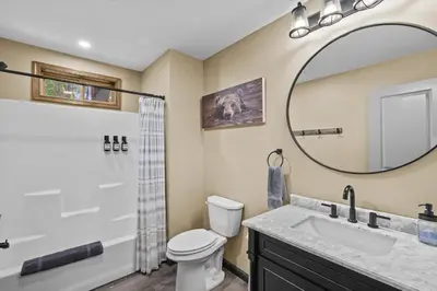 a bathroom with a sink and a mirror at Hot Tub and Community Beach Albrightsville Home! in Albrightsville