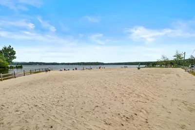 a beach with a group of people on it at Hot Tub and Community Beach Albrightsville Home! in Albrightsville