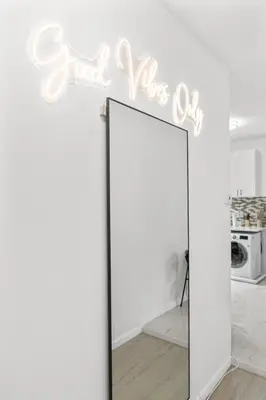 a mirror in a room with a sign that reads read like ok at Style & Comfort 3 Rooms 15 min from NYC in West New York
