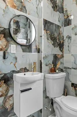 a bathroom with a toilet and a sink and a mirror at Style & Comfort 3 Rooms 15 min from NYC in West New York