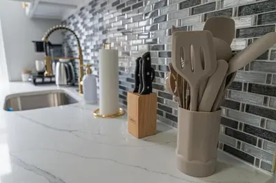 a kitchen counter with knives and utensils on it at Style & Comfort 3 Rooms 15 min from NYC in West New York