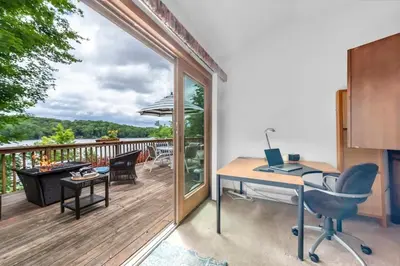an office with a desk and a balcony at Lakefront at the Hideout in Lake Ariel