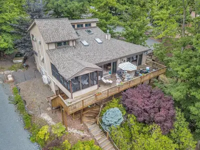 an aerial view of a house with a deck at Lakefront at the Hideout in Lake Ariel