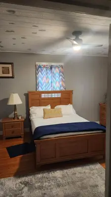 a bedroom with a large bed with a blue blanket at Entire rear squad-bay in Carlisle