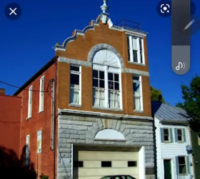a brick building with a clock tower on top of it at Entire rear squad-bay in Carlisle