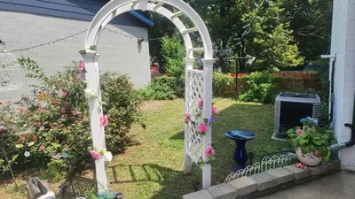 an archway in a yard with flowers at Entire rear squad-bay in Carlisle