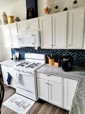 a kitchen with white cabinets and a stove at Entire rear squad-bay in Carlisle