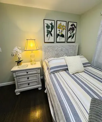 a bedroom with two beds and a table with a lamp at The Peaceful Perch Retreat Near NYC Elle's Home in Trenton