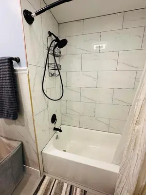 a bathroom with a white tub and a shower at The Peaceful Perch Retreat Near NYC Elle's Home in Trenton