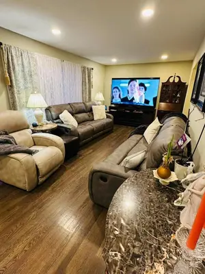 a living room with two couches and a flat screen tv at The Soft Landing Elle's Home Near NYC in Trenton