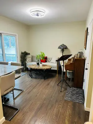 a living room with a couch and a table at The Soft Landing Elle's Home Near NYC in Trenton