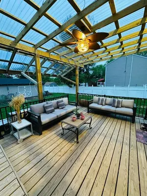 a covered patio with couches and a table on a deck at The Soft Landing Elle's Home Near NYC in Trenton